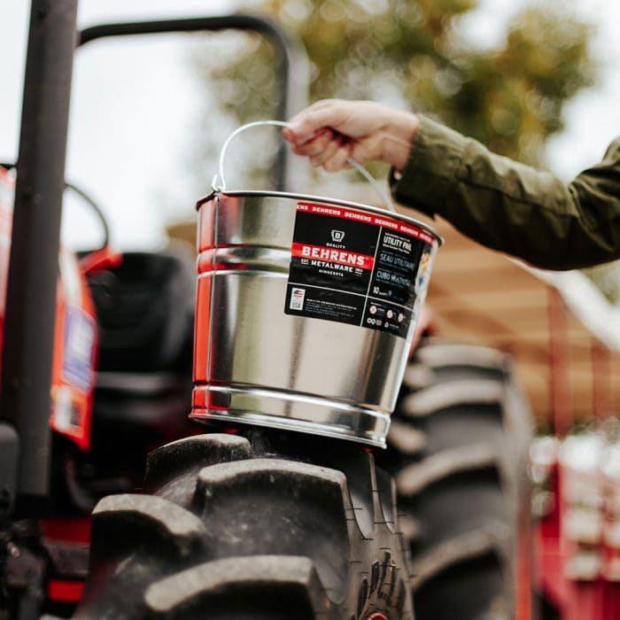 Behrens Metalware Classics Galvanized Steel Pail on a tractor wheel