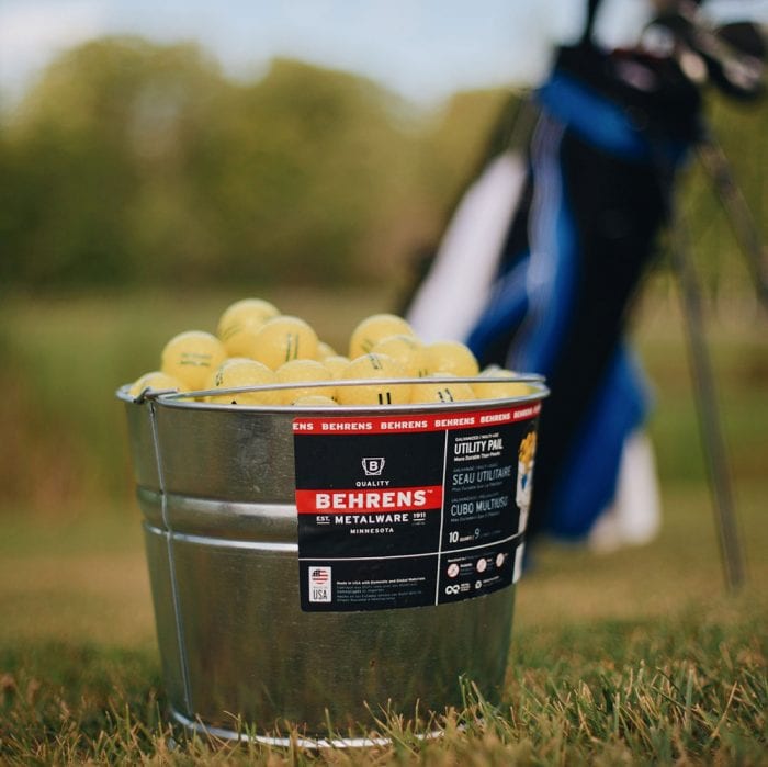Behrens Metalware Classics Galvanized Steel Pail full of golf balls on a golf course