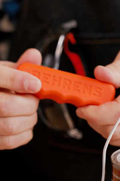 hands holding an orange Behrens comfort grip handle