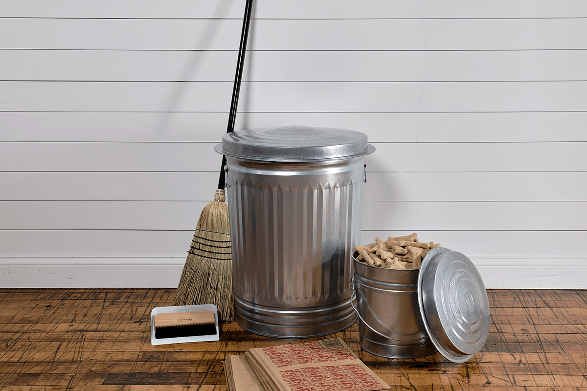 Behrens trash can and locking lid surrounded by cleaning supplies