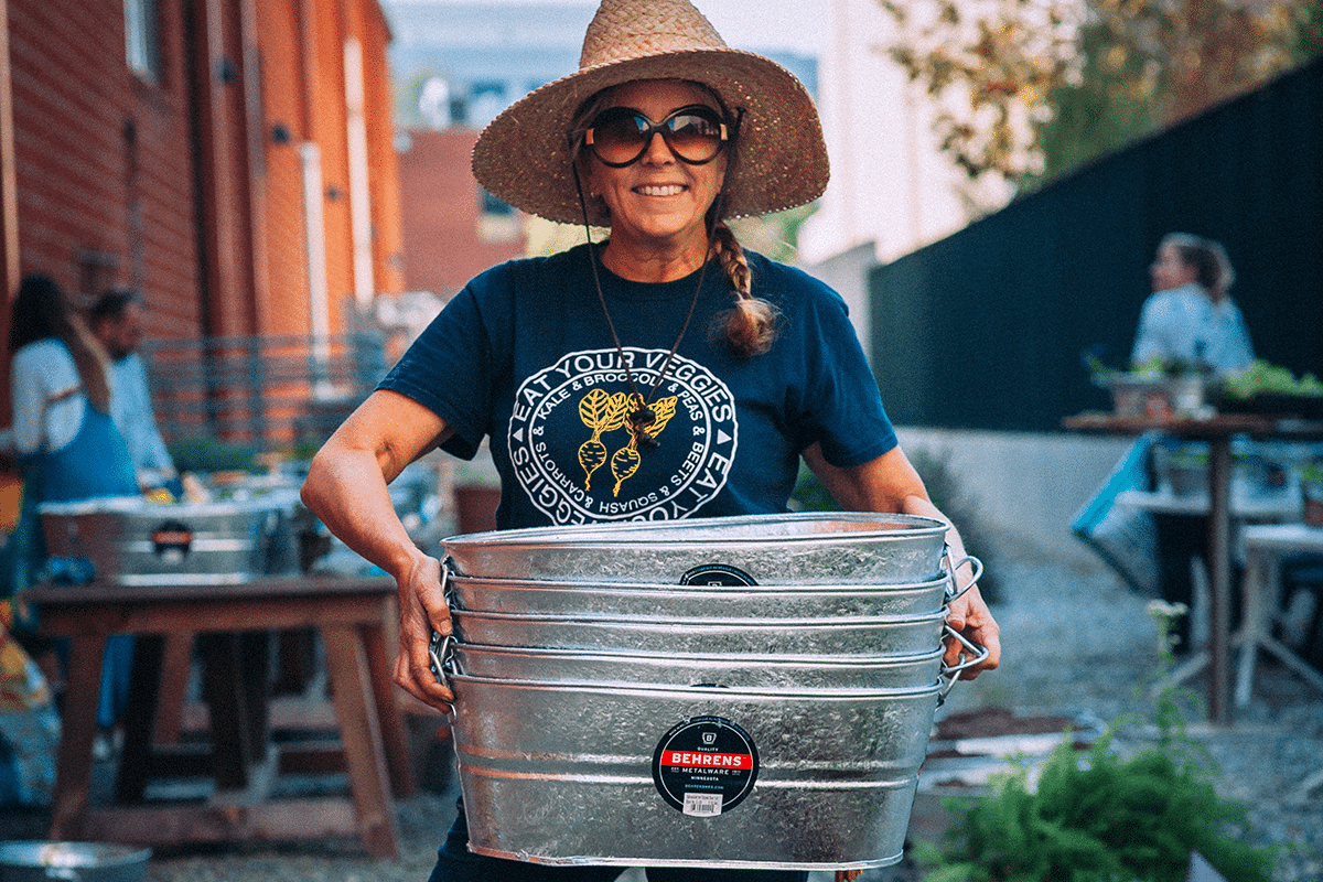 woman holding galvanized steel metal tubs