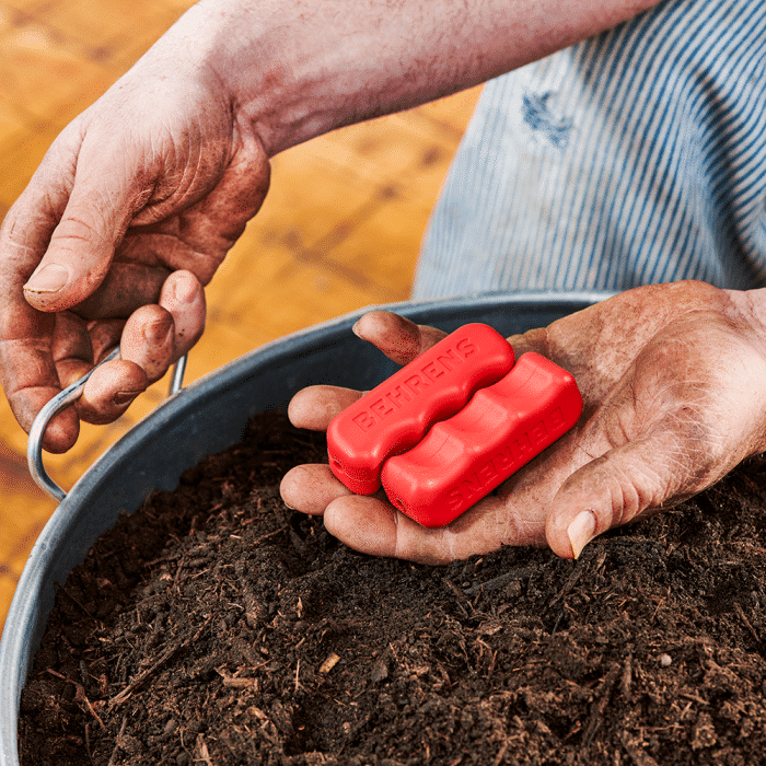 man holding red grips to put on tub handles