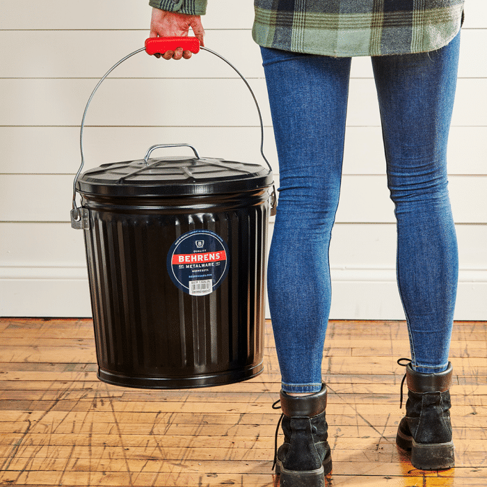 woman carrying black can with red grip