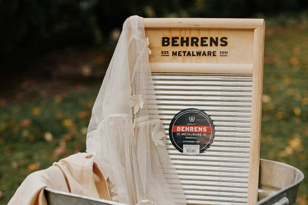 Metal washboard in a galvanized tub with clothes to be washed