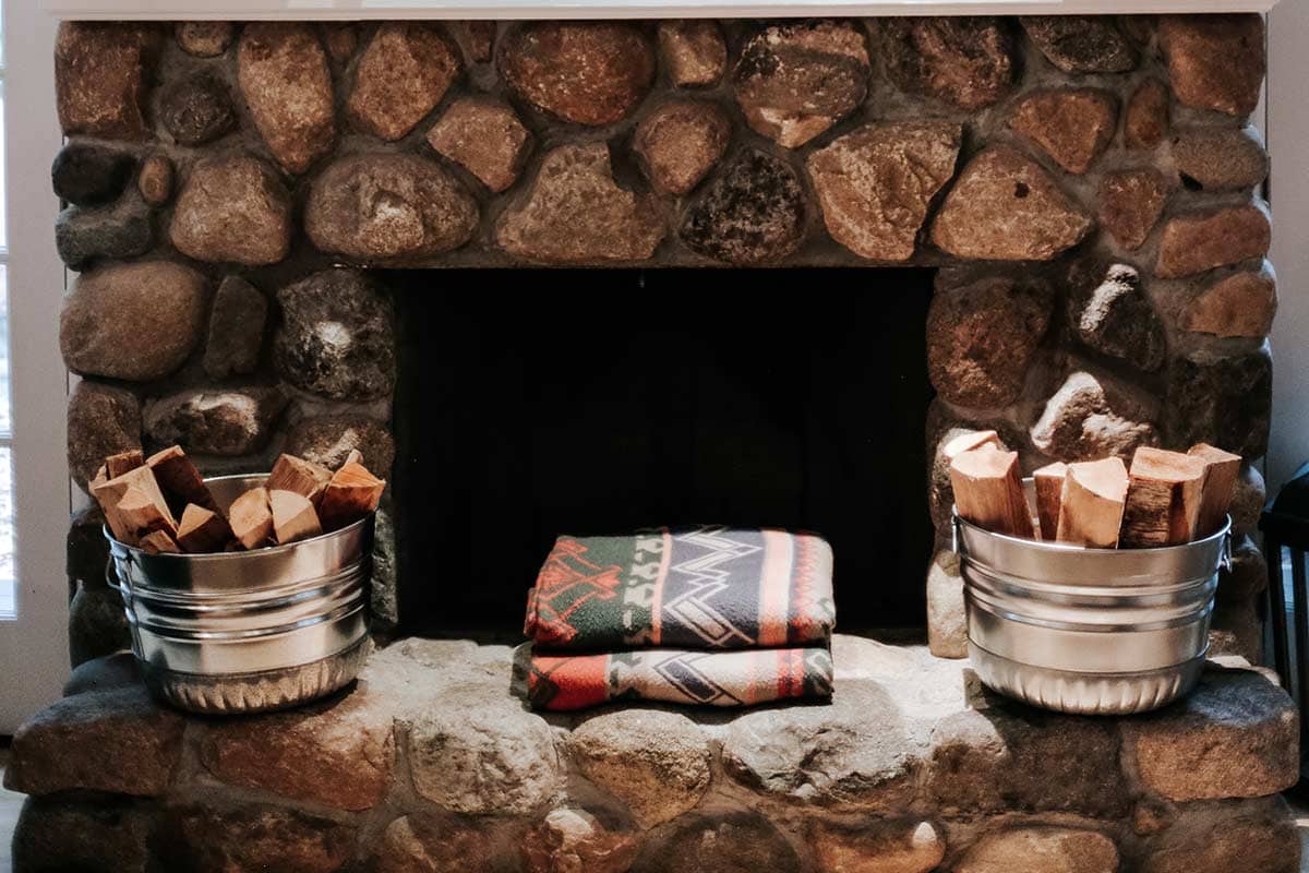 Galvanized steel tubs holding chopped wood on a fireplace mantel