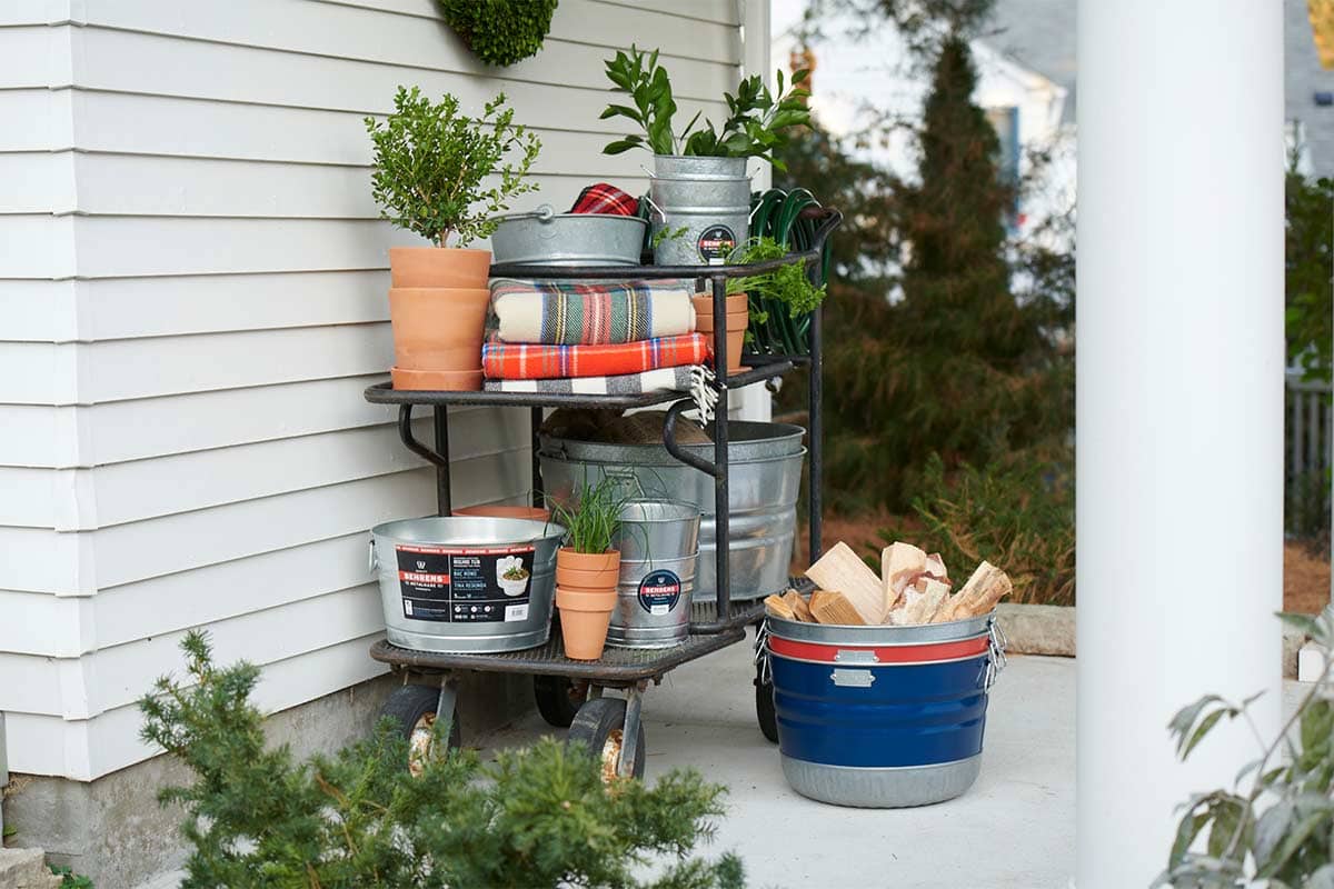 On a patio with gardening equipment featuring galvanized steel tubs.